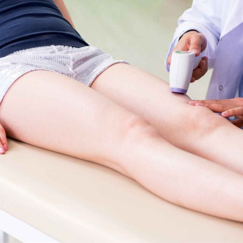 Doctor Performing Lumenis® M22™ IPL- Three sessions. on patient Legs | Manhattan Laser Spa in NYC