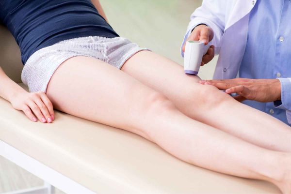 Doctor Performing Lumenis® M22™ IPL- Three sessions. on patient Legs | Manhattan Laser Spa in NYC