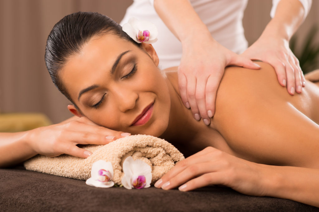 Young Woman Receiving Relaxing Back Massage At Spa | Manhattan Laser Spa in NYC