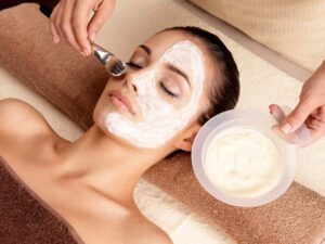 Beautician applying VI-Peels facial on woman's face | Manhattan Laser Spa in NYC