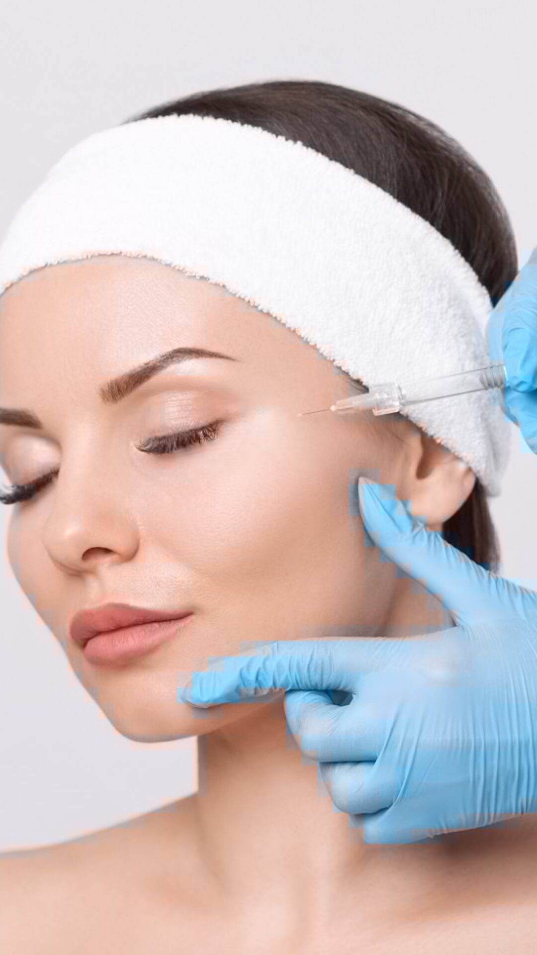Cosmetologist makes rejuvenating anti wrinkle injections on the Cosmetologist makes rejuvenating anti wrinkle injections on the face of a beautiful brunette woman. Female aesthetic cosmetology in a beauty salon.